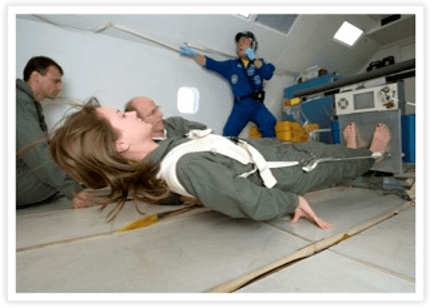 NASA astronaut in zero gravity environment standing on a vibration plate