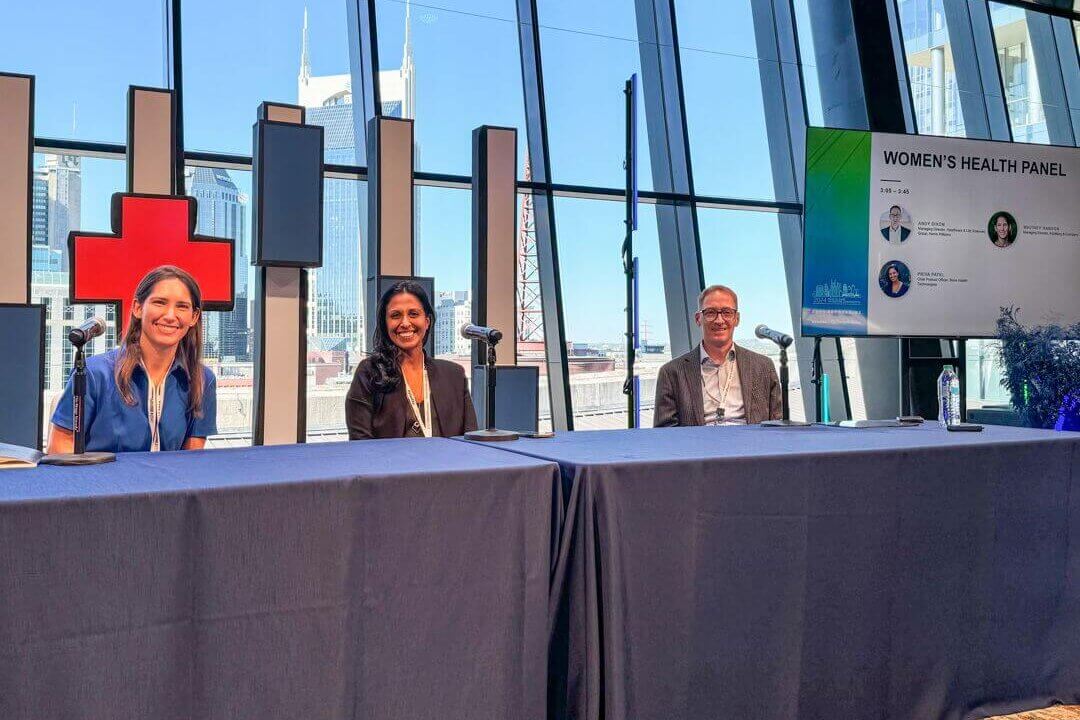 Speakers seated on stage behind a table